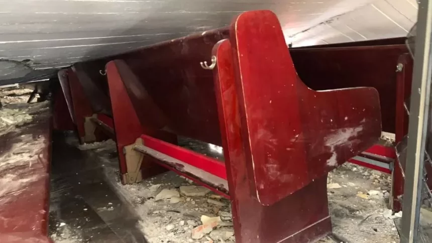 Photos from inside the church show the roof on top of the pews Photo: Reuters